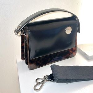 Kara Pinch Tortoise Shoulder Bag with crossbody strap